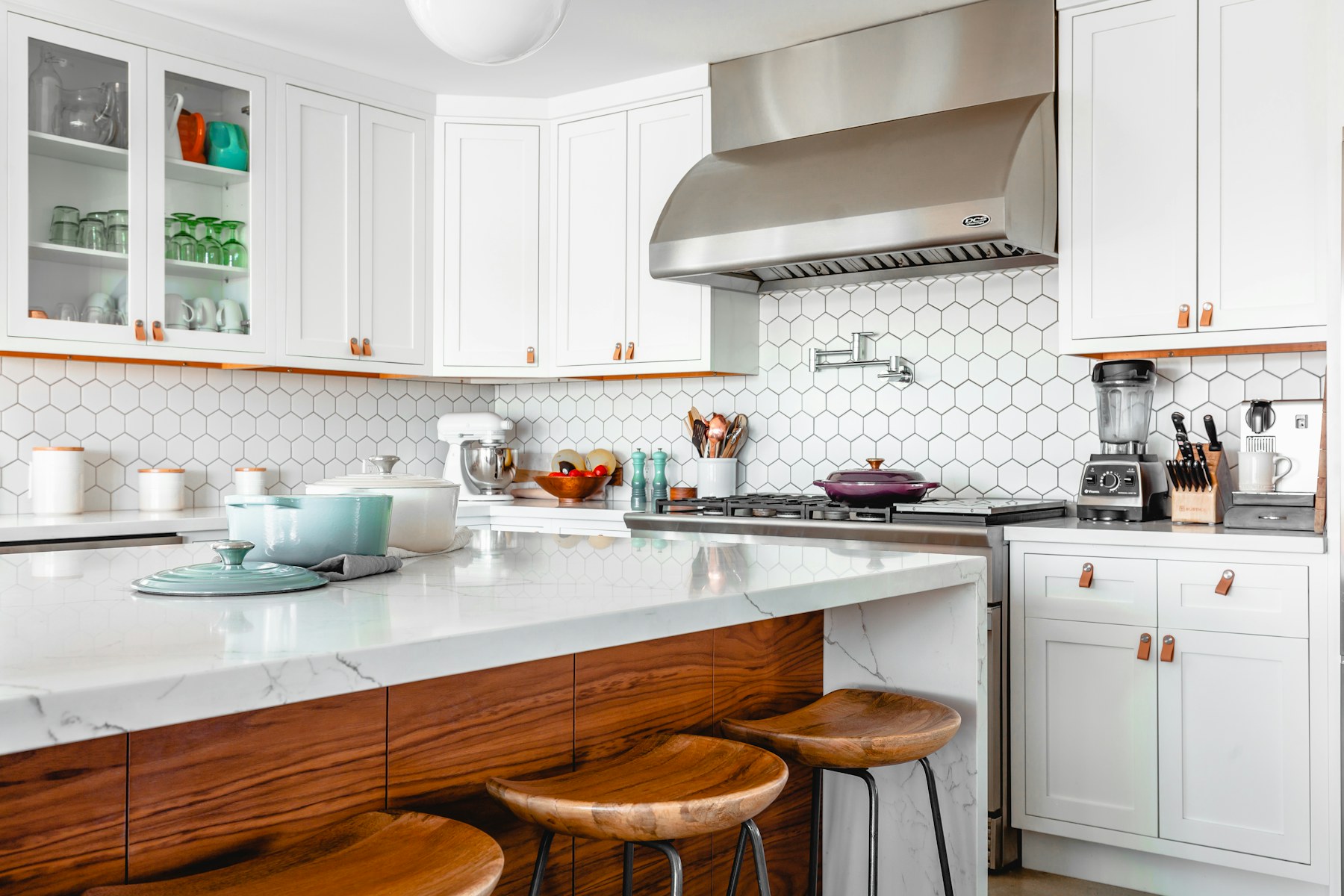 Kitchen with pale cabinetry and a stone island
